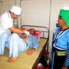 Bác sỹ Bệnh viện Đa khoa huyện Mường Lát khám cho bệnh nhân đến từ tỉnh Huaphanh. (Ảnh: Nguyễn Nam/TTXVN)