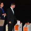 Thủ tướng New Zealand Bill English (phải) và phu nhân bỏ phiếu tại điểm bầu cử ở Wellington ngày 21/9. (Nguồn: AFP/TTXVN)