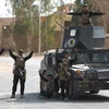 Các lực lượng Iraq tại thành phố al-Qaim, tỉnh Anbar sau khi giải phóng thành phố này từ IS ngày 4/11. (Nguồn: AFP/TTXVN)