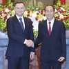 Chủ tịch nước Trần Đại Quang đón tiếp Tổng thống Andrzej Duda. (Ảnh: Nhan Sáng/TTXVN)