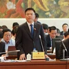 Bộ trưởng Bộ Tư pháp Lê Thành Long trả lời chất vấn các đại biểu tại phiên họp. (Ảnh: An Đăng/TTXVN)