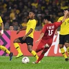 Pha ghi bàn của cầu thủ Việt Nam Phạm Đức Huy vào lưới Malaysia trong trận lượt đi chung kết AFF Suzuki Cup 2018, Kuala Lumpur, Malaysia ngày 11/12. (Nguồn: AFP/TTXVN)