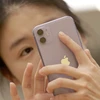 Một người tiêu dùng Trung Quốc sử dụng iPhone 11. (Nguồn: Reuters)