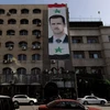 Chân dung Tổng thống Bashar Assad treo trên một tòa nhà ở thủ đô Damscus. (Nguồn: THX/TTXVN)