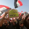 Các thành viên lực lượng bán quân sự Iraq tuần hành trên quảng trường Tahrir, Baghdad, yêu cầu Thổ Nhĩ Kỳ rút binh sỹ khỏi Iraq. (Nguồn: AFP/TTXVN)
