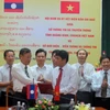 Đại diện lãnh đạo Sở Thông tin và Truyền thông tỉnh Quảng Bình và Sở Bưu điện, Viễn thông và Thông tin tỉnh Khammouane (Lào) trao Biên bản ghi nhớ hợp tác. (Ảnh: Dung Dung/TTXVN)