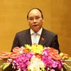 Phó Thủ tướng Nguyễn Xuân Phúc trình bày Báo cáo của Chính phủ tại phiên khai mạc. (Ảnh: Nhan Sáng/TTXVN)