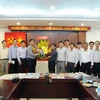 Bí thư Thành ủy TP. Hồ Chí Minh Đinh La Thăng tặng hoa chúc mừng các cán bộ, phóng viên cơ quan TTXVN khu vực phía Nam. (Ảnh: An Hiếu/TTXVN)