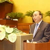 Thủ tướng Nguyễn Xuân Phúc trình bày Tờ trình về cơ cấu số lượng thành viên Chính phủ. (Ảnh: Trọng Đức/TTXVN)