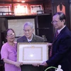 Ông Hà Anh Dân, (ngoài cùng bên phải) đang trao quyết định của Đảng Cộng sản Việt Nam tặng Huy hiệu 65 năm tuổi Đảng cho ông Trần Văn Mỹ. (Ảnh: Phạm Kiên/Vietnam+)