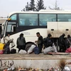 Quân nổi dậy Syria rời khỏi Aleppo ngày 22/12. (Nguồn: AFP/TTXVN)