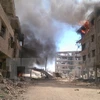 Khói bốc lên sau cuộc không kích ở thị trấn Daraya, khu vực bên ngoài thủ đô Damascus ngày 16/8. (Nguồn: AFP/TTXVN)