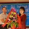 Tham tán Nguyễn Mạnh Cường tặng hoa chúc mừng đại diện Hội Phụ nữ Việt Nam tại Campuchia tại buổi gặp mặt. (Ảnh: Chanh Đa/TTXVN)