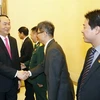 Chủ tịch nước Trần Đại Quang đến thăm và nói chuyện với cán bộ, nhân viên Đại sứ quán Việt Nam tại Trung Quốc. (Ảnh: Nhan Sáng/TTXVN)