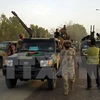 Các binh sỹ LNA tiến vào thành phố miền Đông Benghazi sau khi giải phóng khu vực al-Jufra từ các nhóm khủng bố ngày 5/6. (Nguồn: AFP/TTXVN)