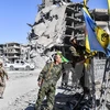 Lực lượng dân chủ Syria (SDF) do Mỹ hậu thuẫn sau khi giải phóng hoàn toàn thành phố Raqqa từ IS ngày 17/10. (Nguồn: AFP/TTXVN)