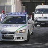 Xe cảnh sát và xe cứu thương mang thi thể ông Kim Jong-nam rời bệnh viện ở Putrajaya, Malaysia ngày 15/2. (Nguồn: EPA/TTXVN)