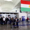 Hành khách tại sân bay Arbil, khu tự trị người Kurd, Iraq ngày 29/9. (Nguồn: AFP/TTXVN)