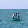 Ngư dân tháo dỡ bẫy tôm hùm trên vùng biển Phan Thiết. (Ảnh: Nguyễn Thanh/TTXVN)