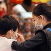 Trẻ em đeo khẩu trang để phòng tránh lây nhiễm cúm tại Hong Kong, Trung Quốc. (Nguồn: AFP/TTXVN)