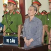 Bị cáo Lê Đình Lượng nghe bản án luận tội tại phiên tòa. (Ảnh: Bích Huệ/TTXVN)