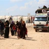Người dân Syria tới trại tị nạn ở Kafr Lusin, phía bắc tỉnh Idlib, gần biên giới Thổ Nhĩ Kỳ, sau khi phải rời bỏ nhà cửa tránh xung đột ngày 9/9. (Ảnh: AFP/TTXVN)