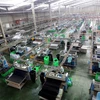 Dây chuyền sản xuất giày, dép xuất khẩu tại Công ty TNHH Midori Safety Footwear Việt Nam, vốn đầu tư của Nhật Bản tại khu công nghiệp Điện Nam-Điện Ngọc (Quảng Nam). (Ảnh: Danh Lam/TTXVN)