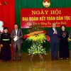 Đồng chí Trần Quốc Vượng tặng hoa chúc mừng cán bộ và nhân dân xã Kim Bình. (Ảnh: Quang Cường/TTXVN)