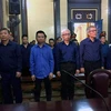 Các bị cáo đứng nghe đại diện Viện Kiểm sát luận tội trong phiên tòa ngày 7/12. (Ảnh: Thành Chung/TTXVN)