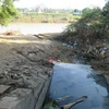 Nước thải xả ra môi trường. (Ảnh minh họa: Nguyễn Thành/TTXVN)