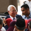 Cựu Thủ tướng Malaysia Najib Razak (giữa) tới tòa án ở Kuala Lumpur ngày 3/4. (Ảnh: AFP/TTXVN)
