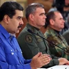 Tổng thống Venezuela Nicolas Maduro (trái) phát biểu tại thủ đô Caracas ngày 30/4/2019. (Ảnh: AFP/TTXVN)