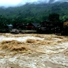 Nước trên thượng nguồn đổ xuống xã Bản Hồ, huyện Sa Pa, tỉnh Lào C, khiến nhiều nhà cửa của người dân bị ảnh hưởng. (Ảnh: Quốc Khánh/TTXVN)
