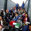 Người di cư Trung Mỹ trên xe tải ở tuyến đường cao tốc Guadalajara-Nayarit, bang Jalisco, Mexico, trong hành trình tới Mỹ ngày 12/11/2018. (Nguồn: AFP/TTXVN)