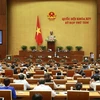 Bộ trưởng Bộ Thông tin và Truyền thông Nguyễn Mạnh Hùng trả lời chất vấn của các đại biểu Quốc hội. (Ảnh: Doãn Tấn/TTXVN)