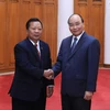 Thủ tướng Nguyễn Xuân Phúc và đồng chí Chansamone Chanyalath, Ủy viên Bộ Chính trị, Bộ trưởng Bộ Quốc phòng Lào. (Ảnh: Thống Nhất/TTXVN)