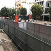 Hàng rào tôn đỏ do Công ty cổ phần May Lê Trực dựng, còn hàng rào màu ghi phía ngoài do UBND phường Điện Biên dựng. (Ảnh Minh Nghĩa/TTXVN)