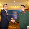 Đại tướng Ngô Xuân Lịch, Bộ trưởng Bộ Quốc phòng gặp song phương Đại tướng Chaichan Changmongkol, Thứ trưởng Bộ Quốc phòng Thái Lan. (Ảnh: Dương Giang/TTXVN)