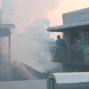 Đám cháy với cột khói cao bao trùm và lan ra cả các khu nhà liền kề của phường Mỹ Bình, thành phố Long Xuyên (An Giang). (Ảnh: Công Mạo/TTXVN)