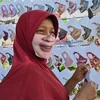 Người dân đeo khẩu trang có in hình mặt cười tại Tangerang, Indonesia ngày 2/6/2020. (Ảnh: AFP/TTXVN)