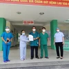 Đại diện lãnh đạo Bệnh viện Phổi Đà Nẵng trao giấy xuất viện cho bệnh nhân 445 mắc COVID-19. (Ảnh: Văn Dũng/TTXVN)