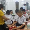 Các em học sinh bị ong đốt được đưa vào Trung tâm Y tế huyện Cam Lộ để điều trị. (Ảnh: TTXVN phát)