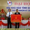 Chủ tịch UBND tỉnh Quảng Trị Võ Văn Hưng trao tặng Cờ thi đua đơn vị dẫn đầu phong trào thi đua năm 2019 cho Hội Nhà báo tỉnh. (Ảnh: Hồ Cầu-TTXVN)