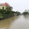 Nước lũ dâng cao khiến hàng ngàn hộ dân vũng trũng xã Hưng Trung, huyện Hưng Nguyên, Nghệ An bị cô lập hoàn toàn. Ảnh: Bích Huệ - TTXVN
