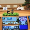 Phó Thủ tướng Vũ Đức Đam và Bộ trưởng Bộ Y tế Nguyễn Thanh Long họp trực tuyến với lãnh đạo Bệnh viện K và Bệnh viện Bệnh nhiệt đới Trung ương. (Ảnh: Lâm Khánh/TTXVN)