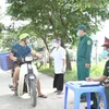 Chốt kiểm soát tiến hành đo thân nhiệt và yêu cầu người dân khai báo y tế tại Hưng Yên. (Ảnh: Đinh Tuấn/TTXVN)