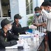 Nhân viên y tế hướng dẫn người đi từ Thành phố Hồ Chí Minh về Đồng Nai thực hiện khai báo y tế tại chốt kiểm soát trên quốc lộ 51, đoạn giao với cao tốc Thành phố Hồ Chí Minh-Long Thành-Dầu Giây. (Ảnh: Lê Xuân/TTXVN)