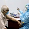 Các y bác sỹ Trung tâm Y tế Quận 11, Tp. Hồ Chí Minh tiêm vaccine Moderna phòng COVID-19 trong đợt 5 cho người trên 65 tuổi, người mắc bệnh mãn tính, người thuộc diện chính sách, có công. (Ảnh: Hồng Giang/TTXVN)