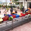 Người dân thực hiện 5K tại điểm bán hàng hóa thiết yếu bình ổn của Tổng công ty Công nghiệp thực phẩm Đồng Nai (Dofico) ở thành phố Biên Hòa. (Ảnh: TTXVN phát)