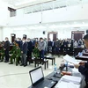 Đại diện Viện Kiểm sát đọc bản luận tội và đề nghị các mức án với 36 bị cáo trong phiên xử ngày 29/11. (Ảnh: Phạm Kiên/TTXVN)